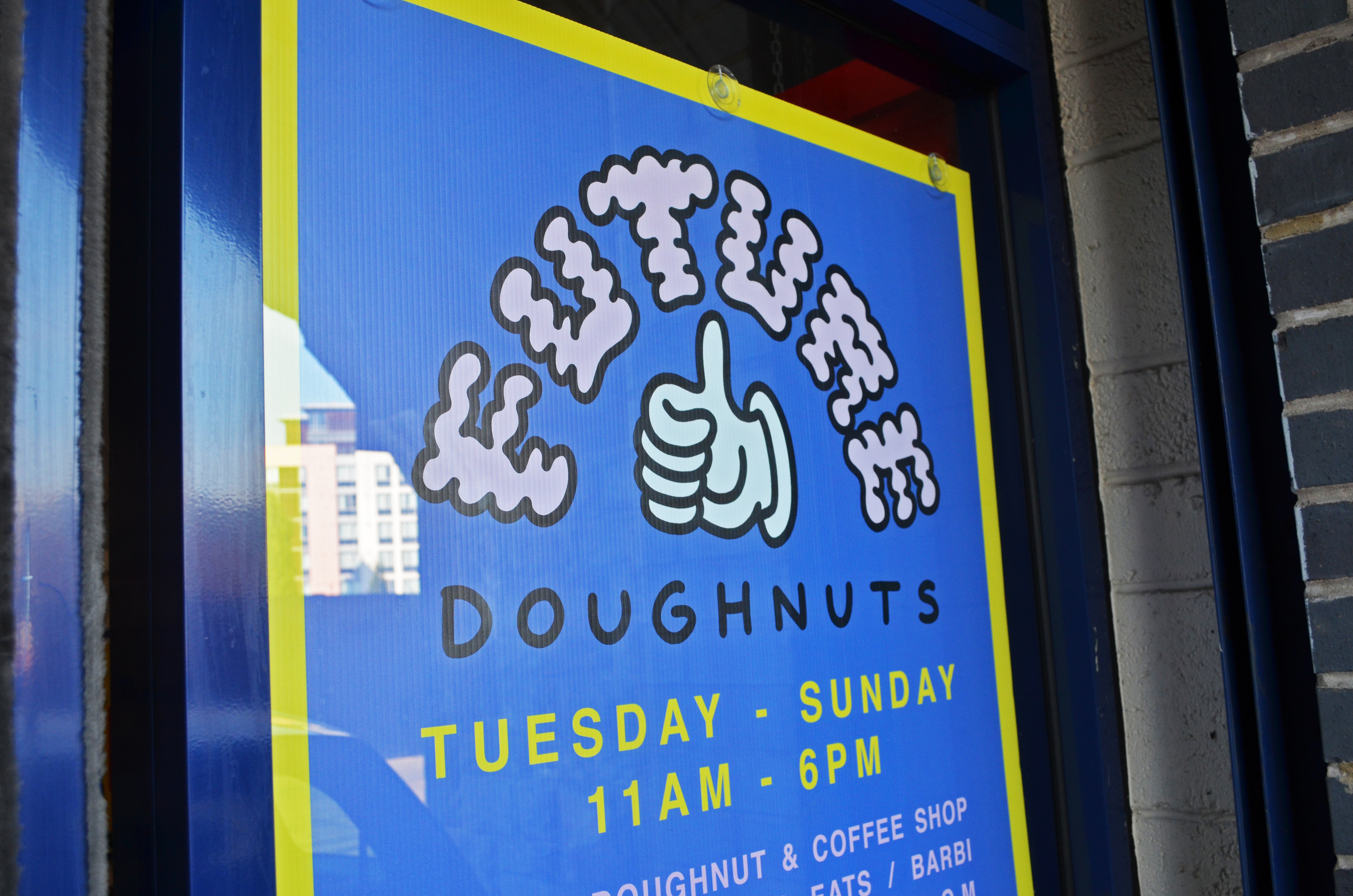 Future Doughnuts store sign with logo and hours