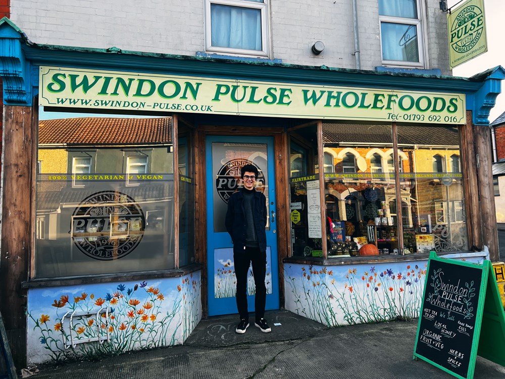 smiling man stands outside swindon pulse wholefoods shop