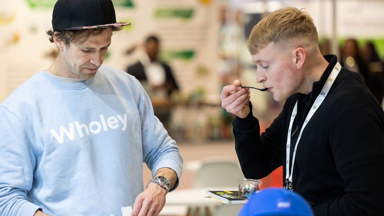 Two young men tasting new products at Natural Food Expo London