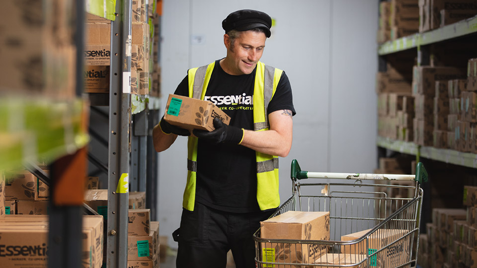 An Essential member preparing an order in the warehouse